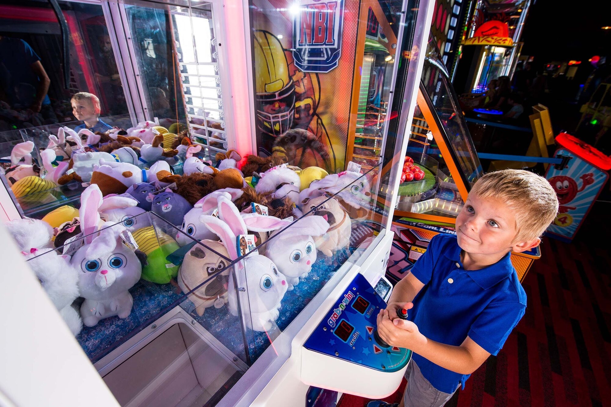 Child Playing Toy Crane Game